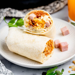 ham breakfast burritos on white circular plate
