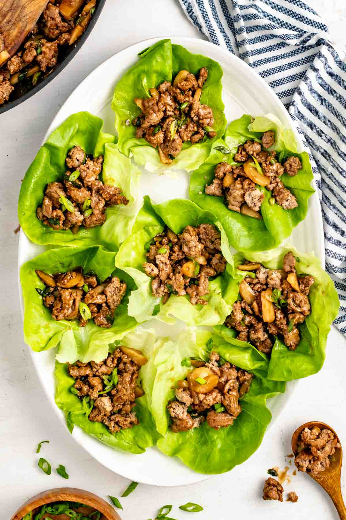 turkey lettuce wraps arranged on oval white plate.