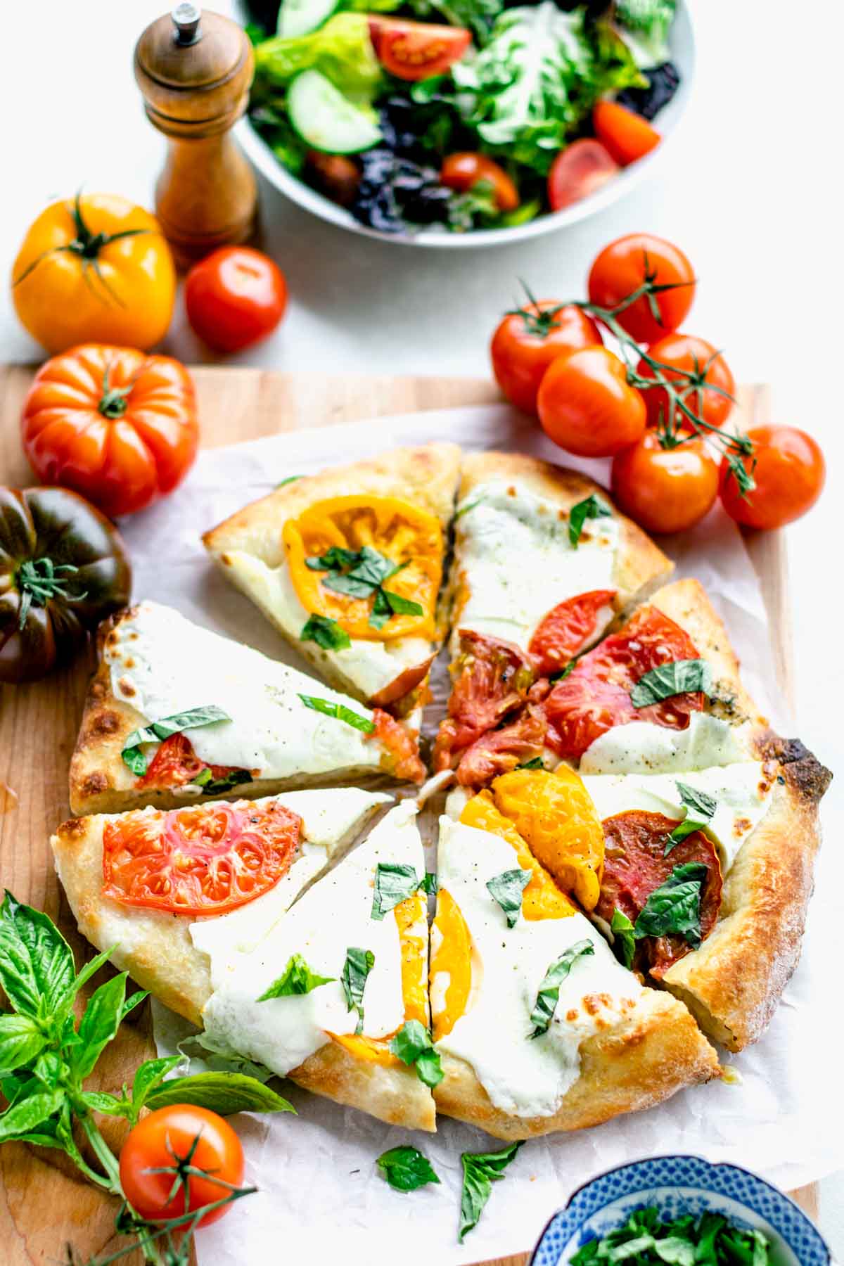 Overhead shot of baked fresh tomato pizza cut into 8 triangle slices