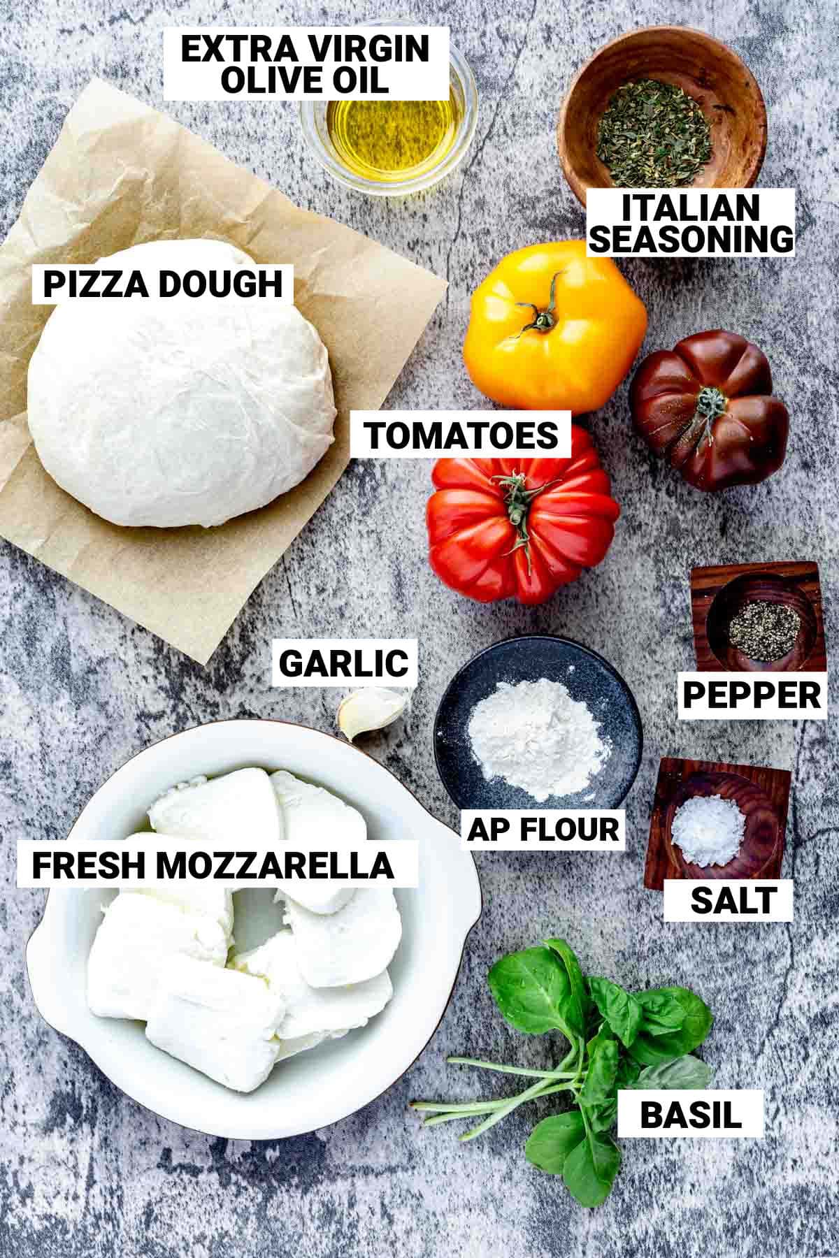 overhead view of caprese pizza ingredients on white counter with text overlay