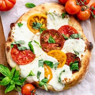 uncut, baked homemade caprese pizza