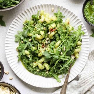 arugula pasta in circular white plate