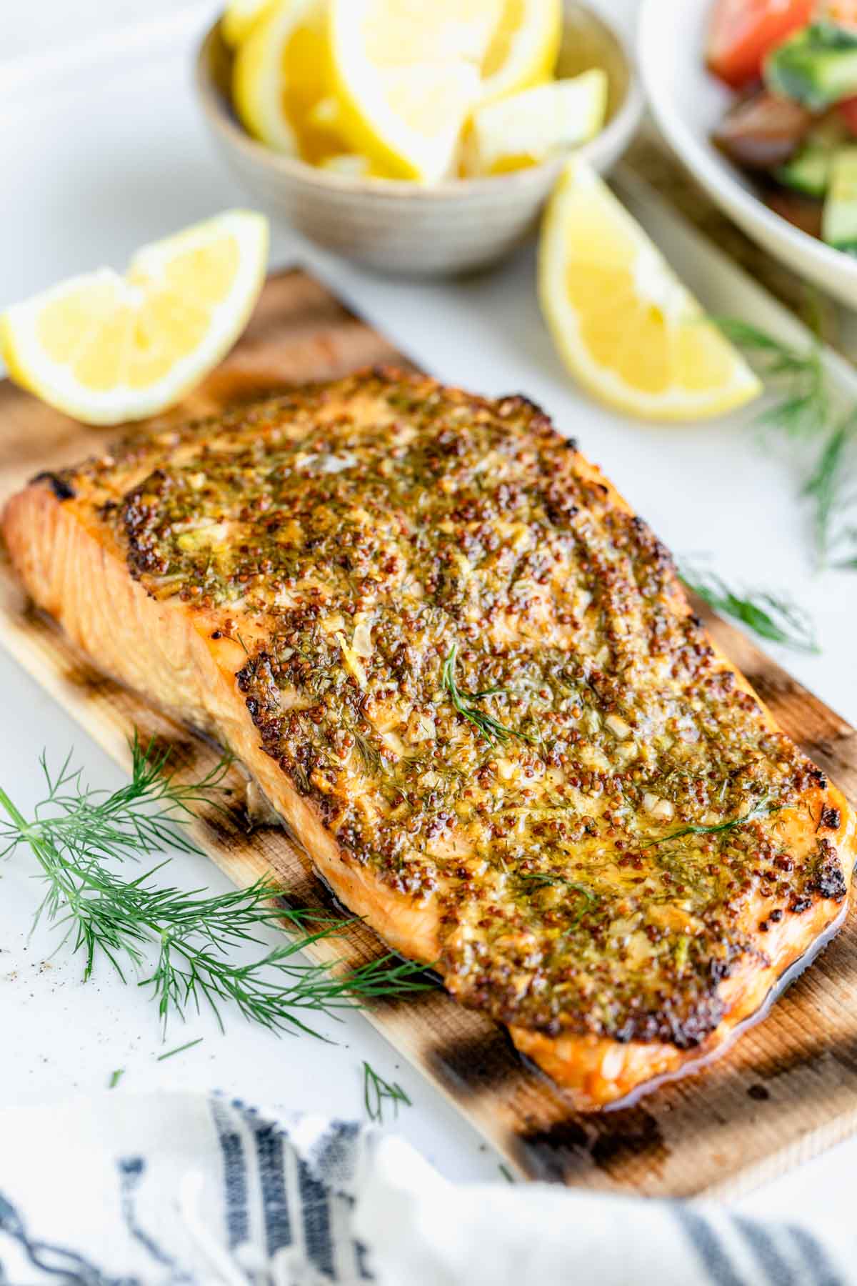 the salmon on the plank with dill sprig