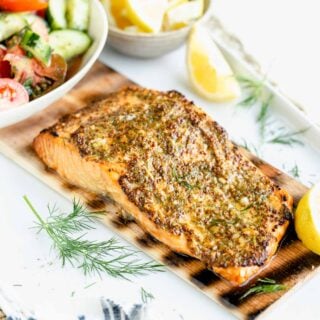 the cedar plank grilled salmon from the side with a cucumber salad