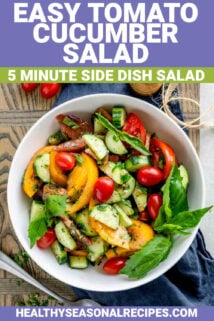 tomato cucumber salad in a white bowl from overhead with a cluster of grape tomatoes and a pepper grinder with text overlay