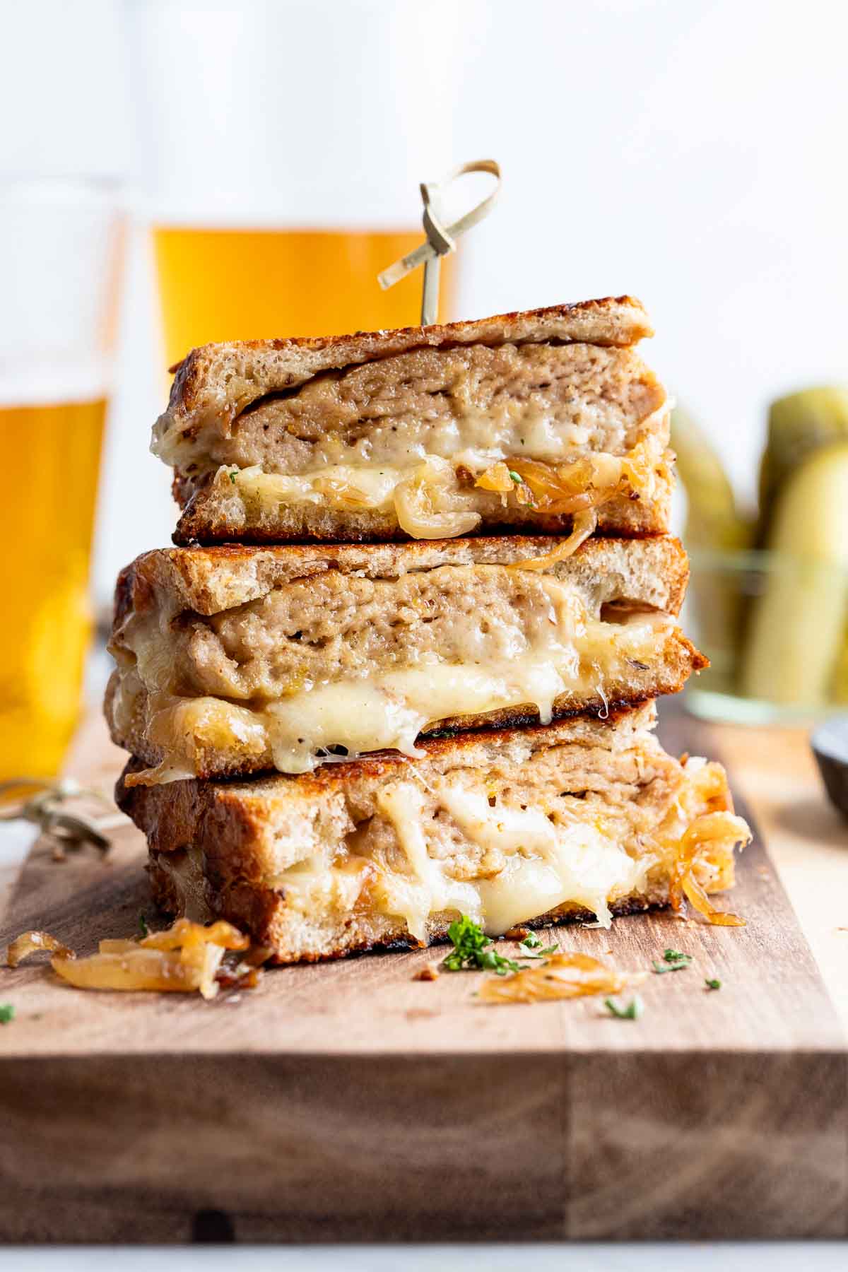 turkey patty melts stacked on top of each other, 3 halves tall with tooth pick holding them together