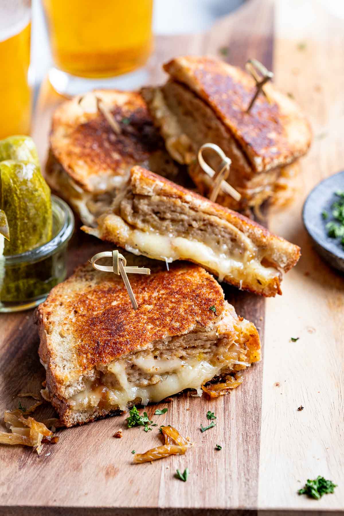 sliced turkey burger sandwiches with toothpicks on a wooden cutting board