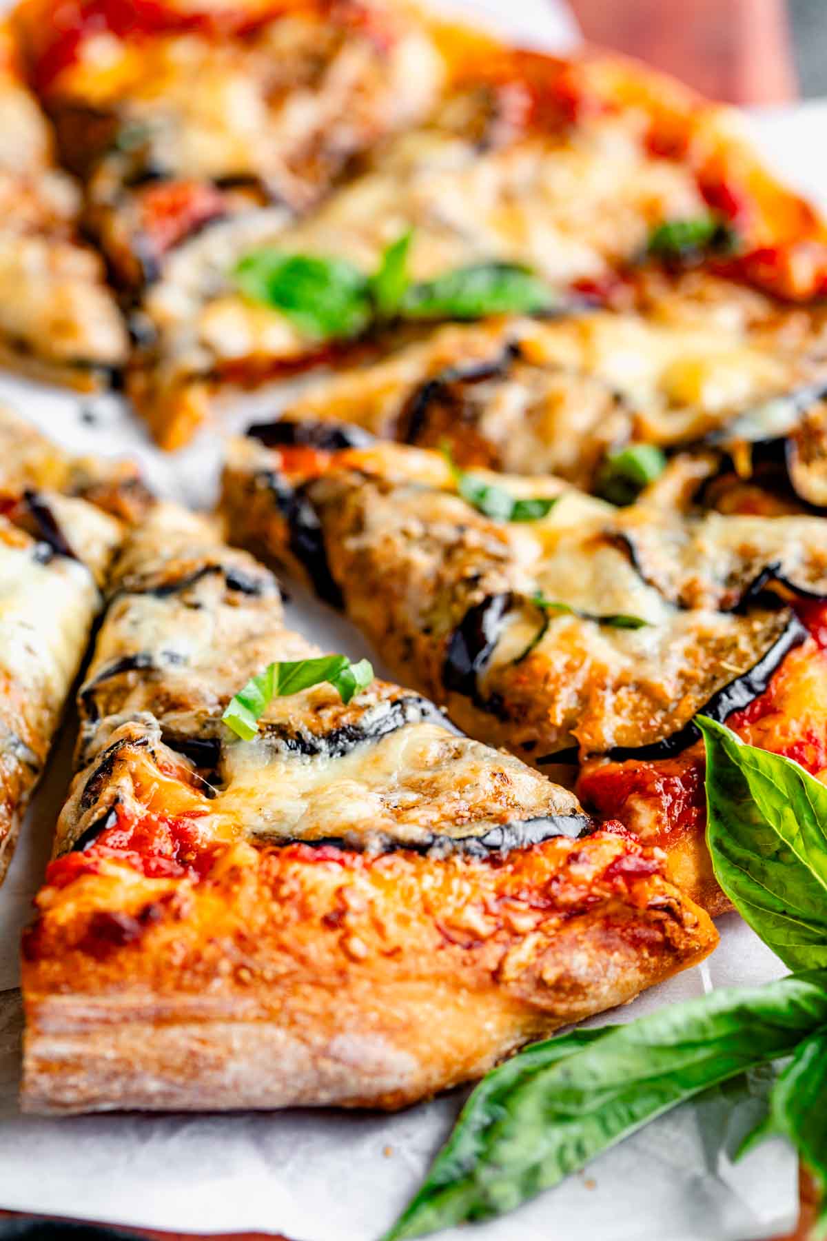 up close photo of a slice of pizza with eggplant