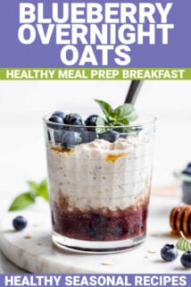 a jar full of blueberry overnight oats with the blueberries on the bottom, overnight oats layered over them, and fresh blueberries and garnish on top