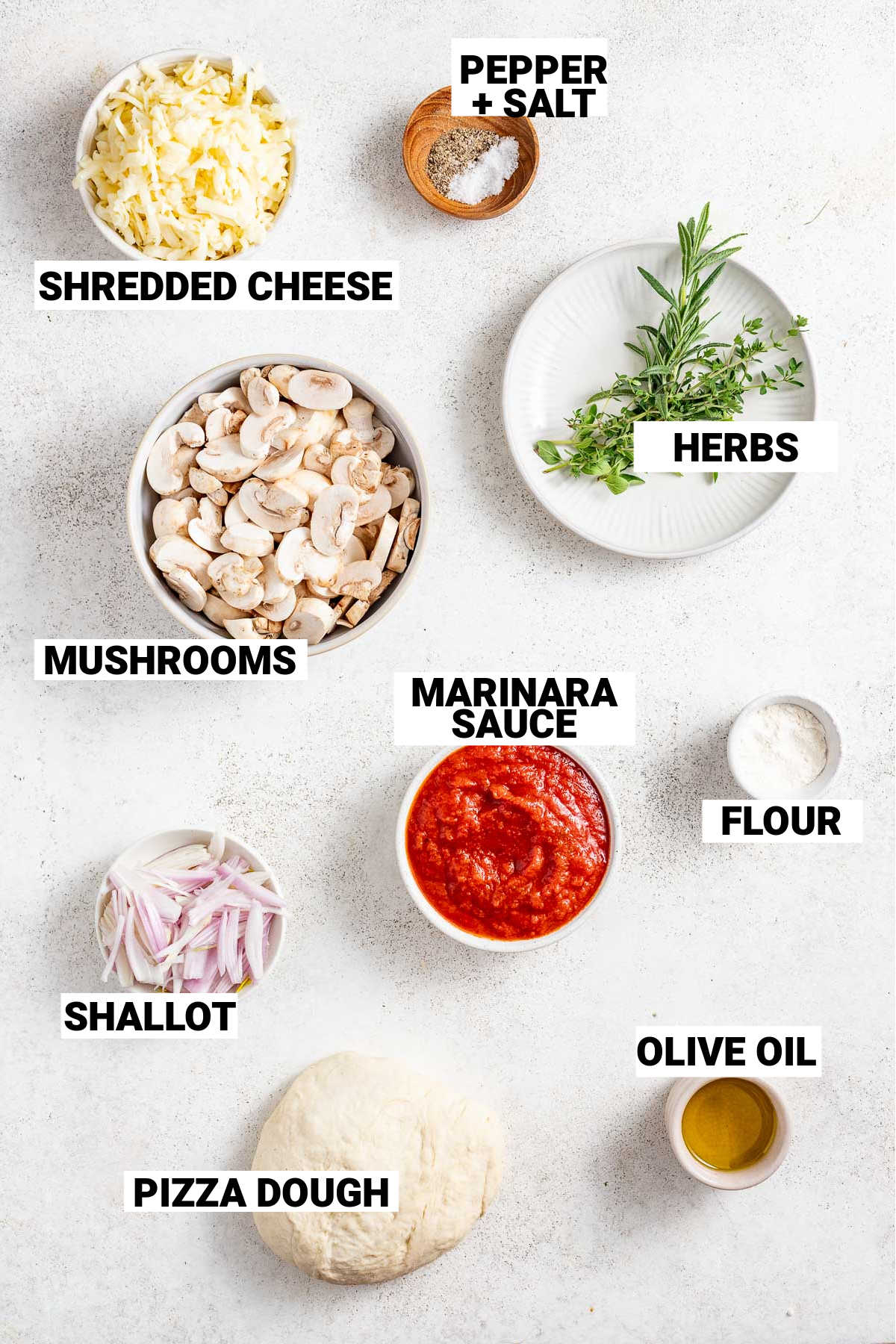 pizza with mushrooom ingredients on white counter with text overlay