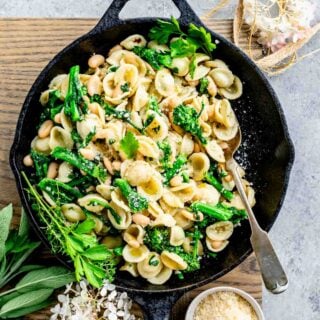 overhead photo of broccoli rabe with pasta in a skillet