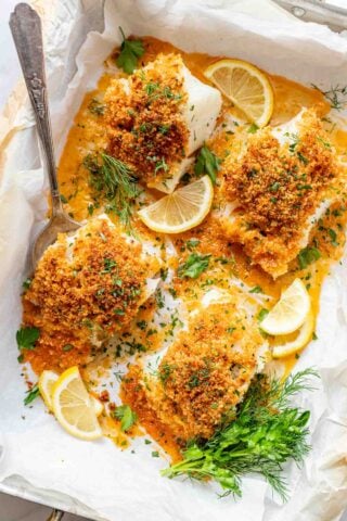 four pieces of pank cod in a parchment lined baking dish