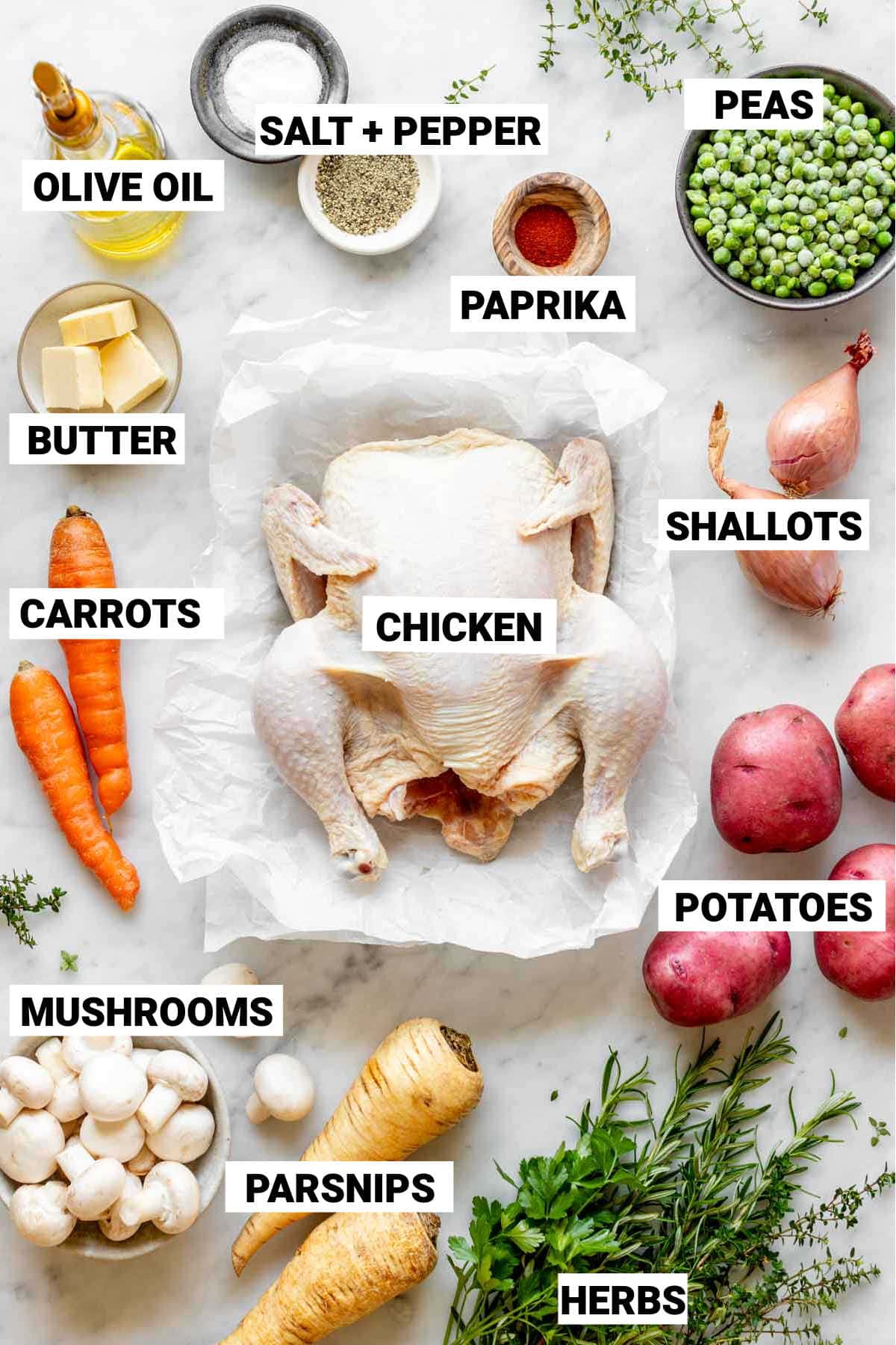 a whole chicken, salt and pepper, peas, paprika, shallots, olive oil, butter, carrots, potatoes, parsnips, mushrooms, and herbs to make a chicken pot roast