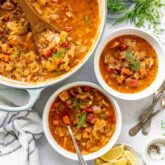 Cabbage soup in a pot with two bowls