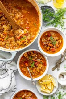 Cabbage soup in a pot with two bowls