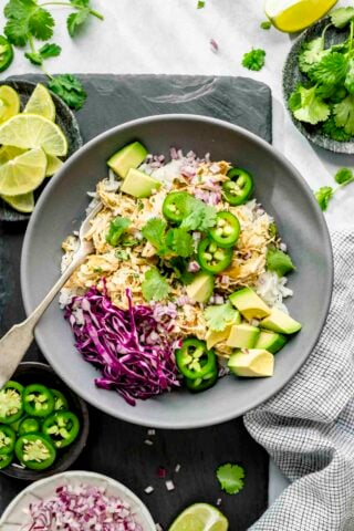 a serving idea: rice bowl with the shredded green chile chicken on top plus toppings