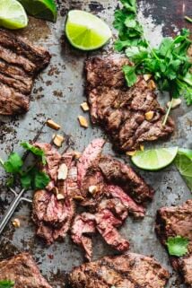 the steak on a baking sheet with cilantro, lime and chopped peanuts