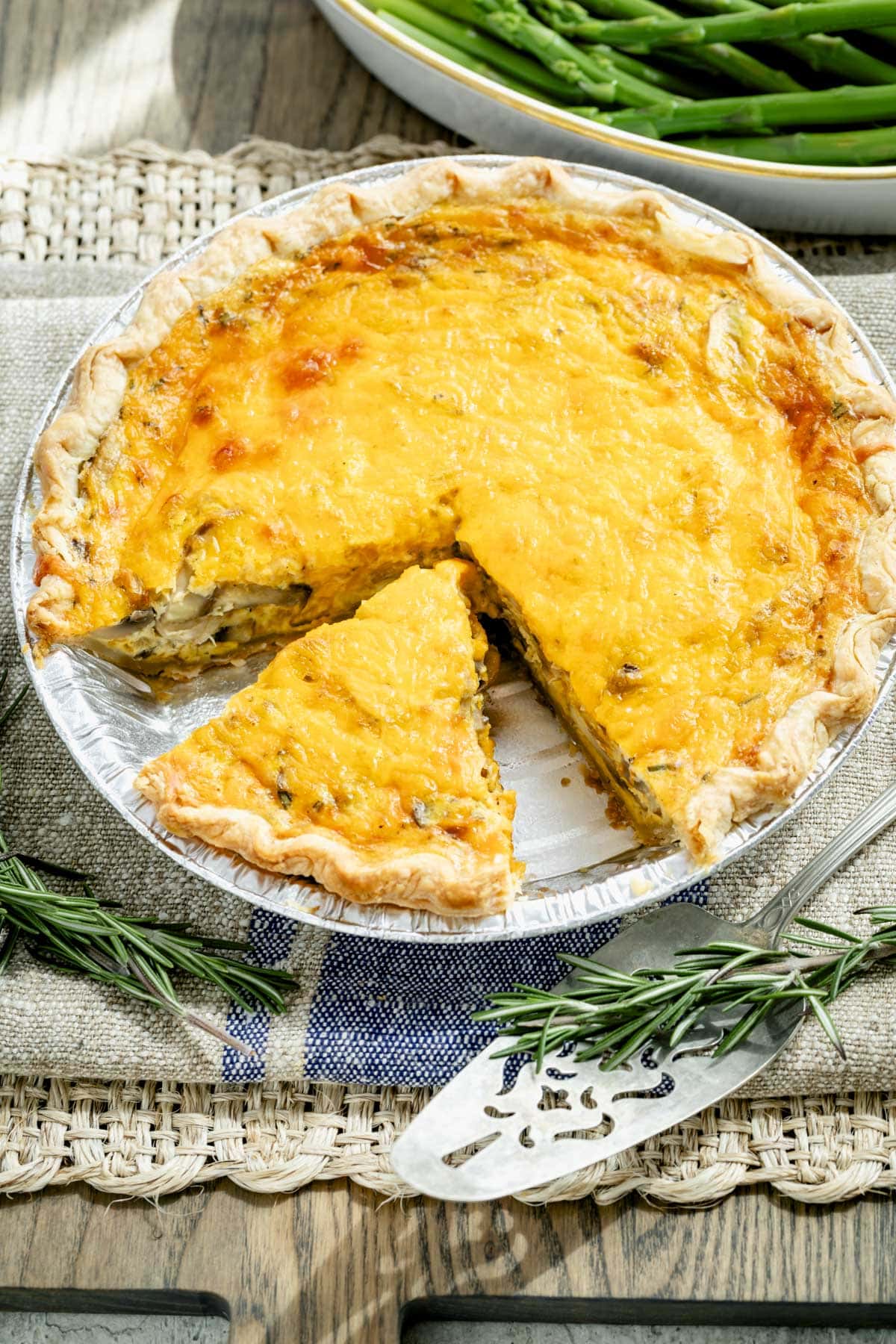 a whole quiche from overhead with one slice removed