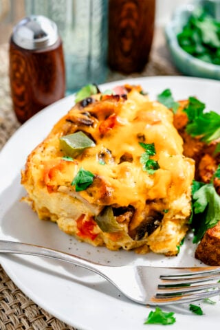 a serving of the casserole on a white dish with home fries