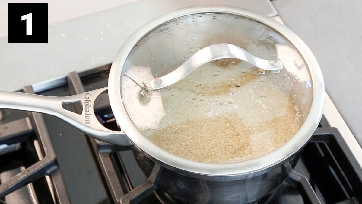 the quinoa cooking in a small saucepan on a stove