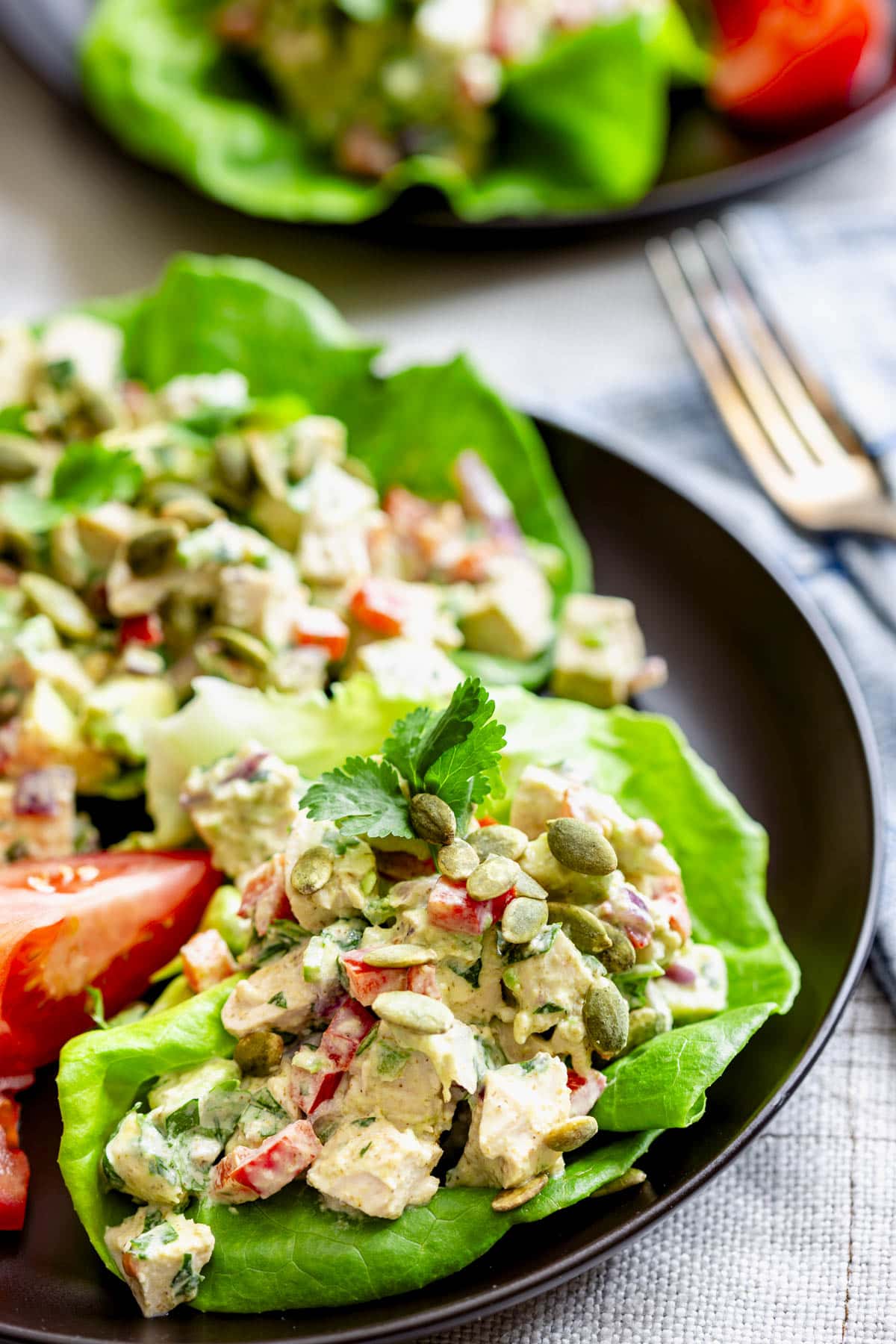 a close-up of one of the lettuce cups with creamy chicken salad with avocado in it