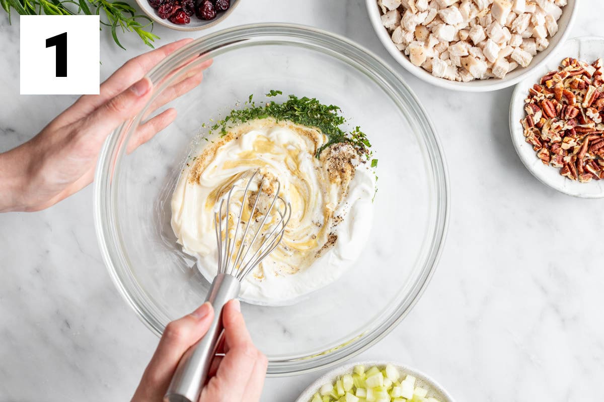 whisking the dressing in a large bowl