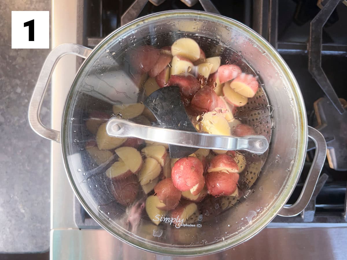 the potatoes steaming in the pot with the lid on