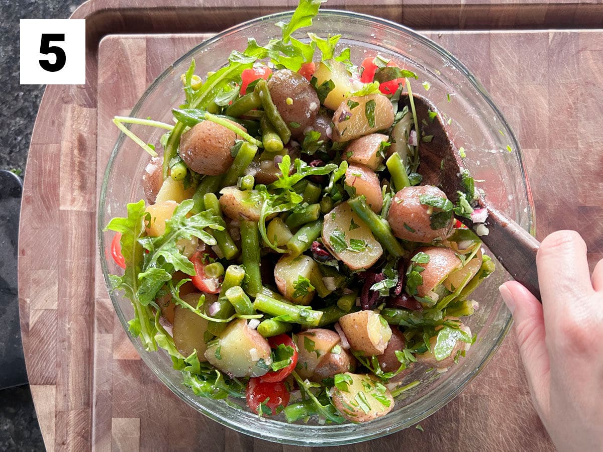 adding in the rest of the salad ingredients