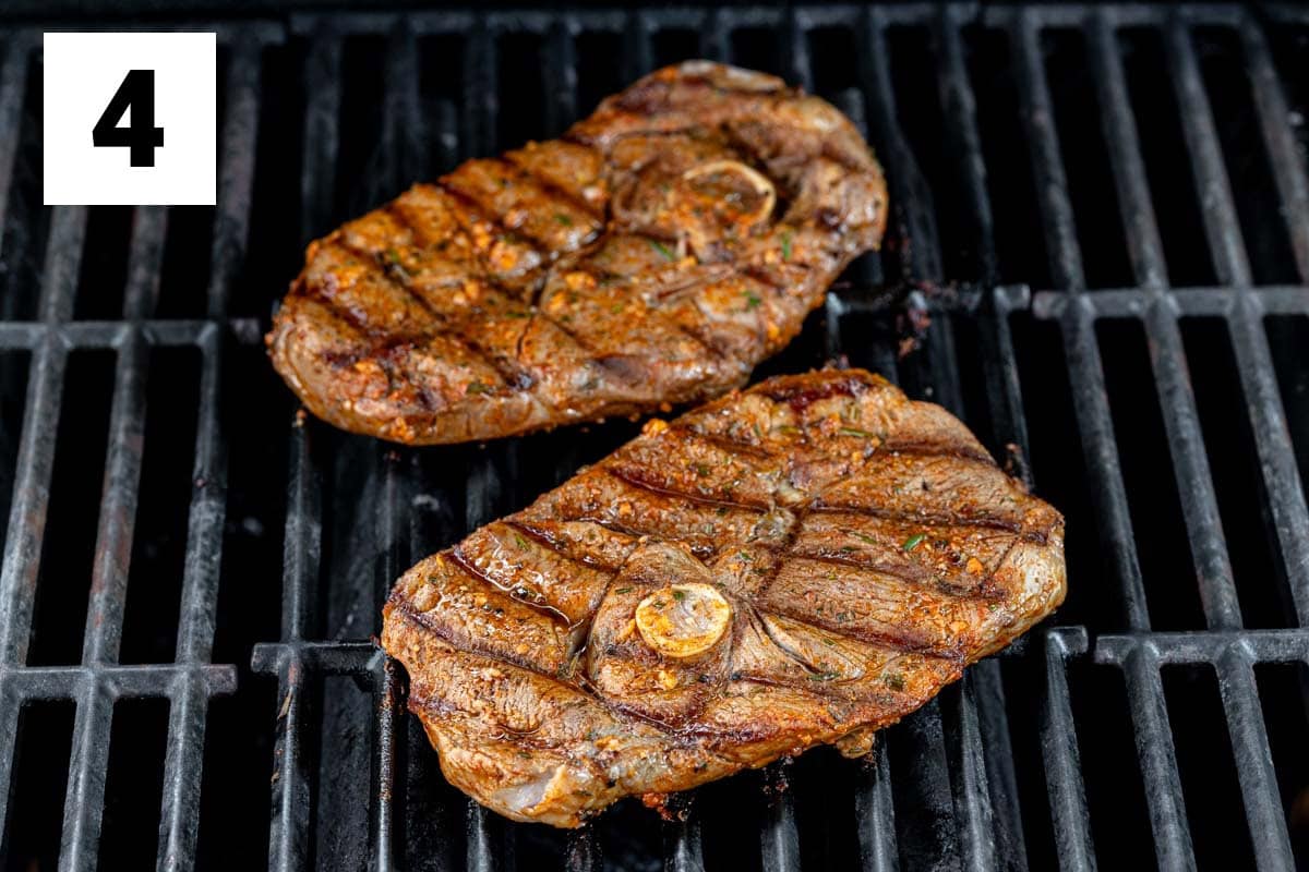 two legs of lamb on a grill