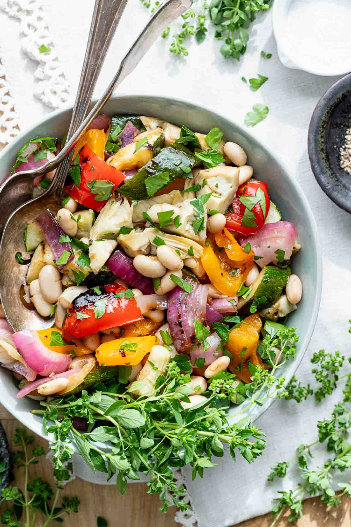 grilled vegetable salad with white beans in circular white bowl
