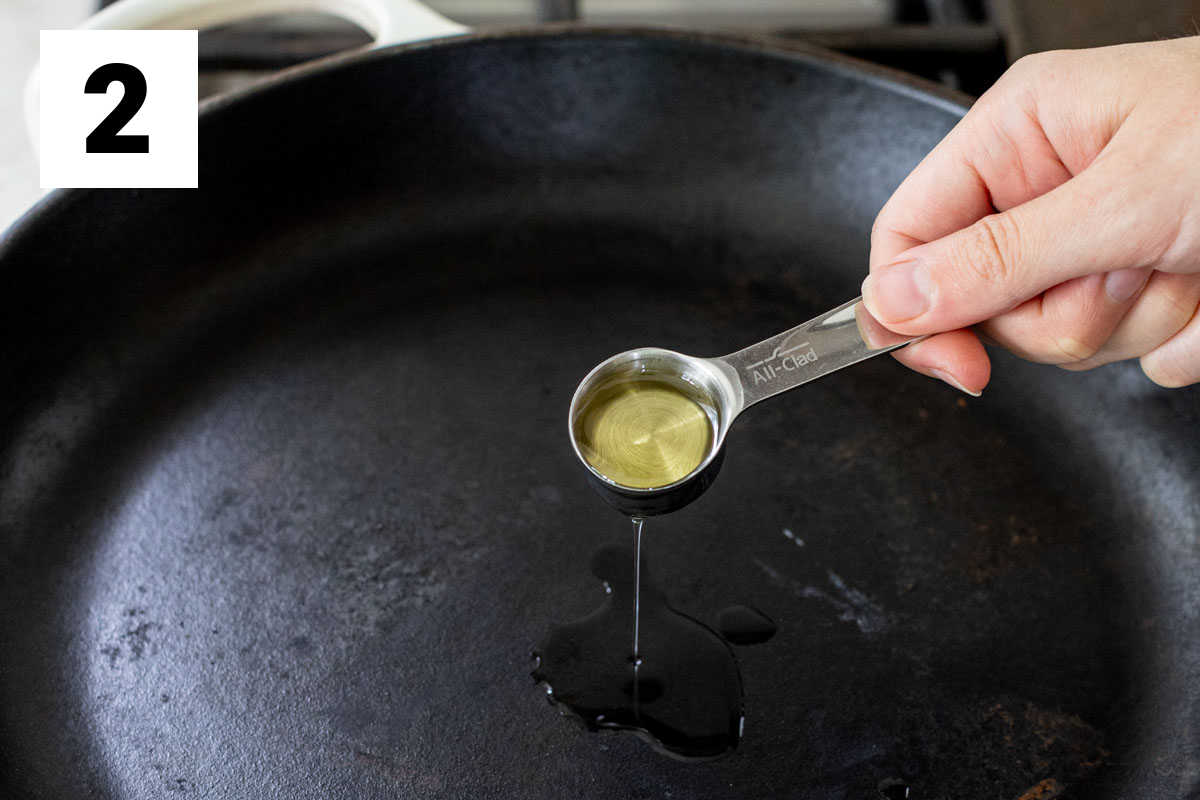 adding oil to the skillet