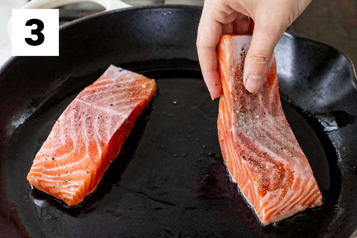 adding the salmon to the hot skillet