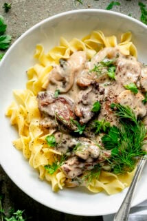 stroganoff on noodles with sprigs of dill