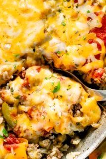 unstuffed peppers skillet with melted yellow cheese on top close up with a scoopful about be be removed