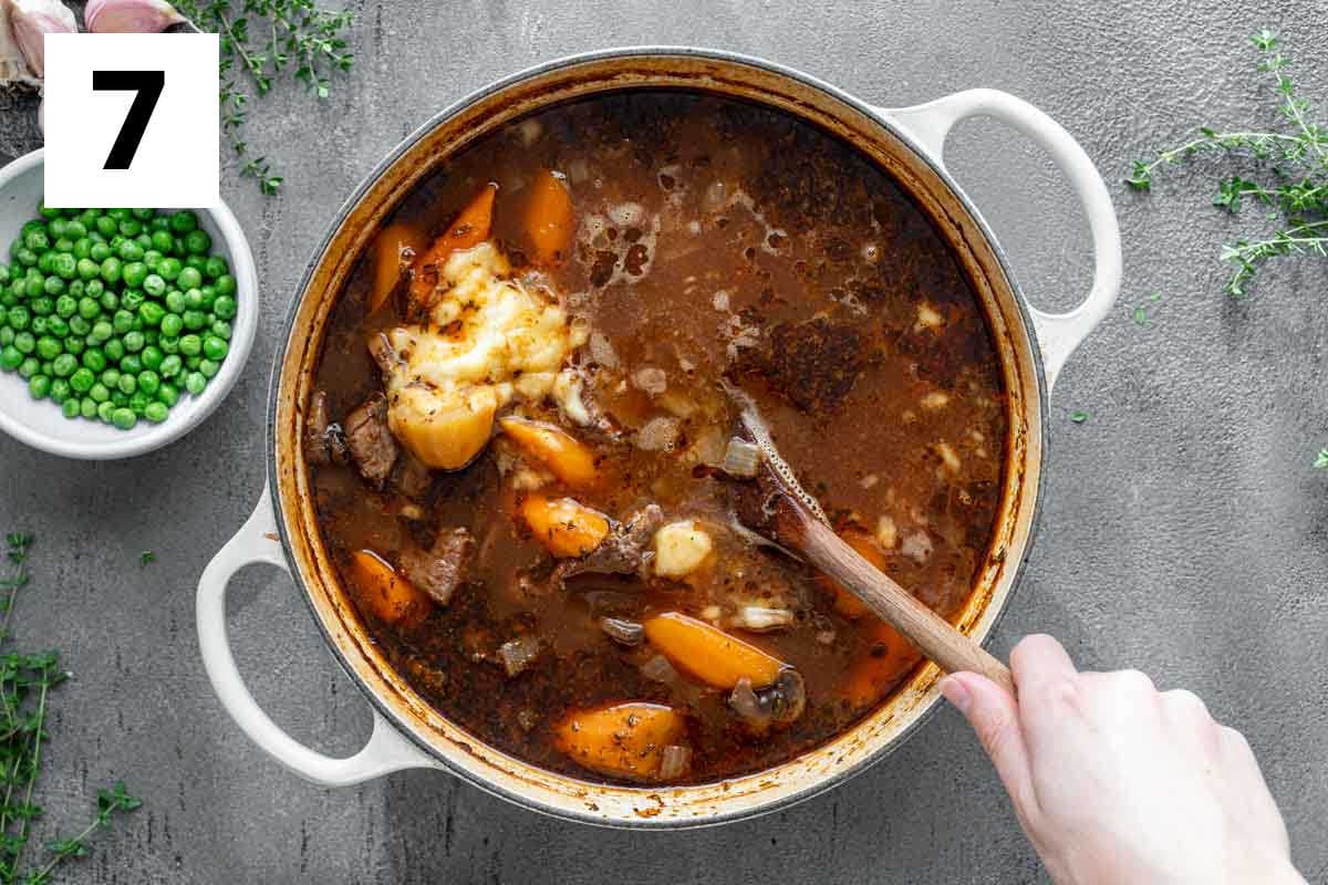 stirring the butter and flour paste into the stew to thicken it