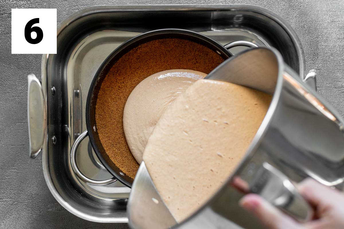 pouring the cheesecake filling into the pan