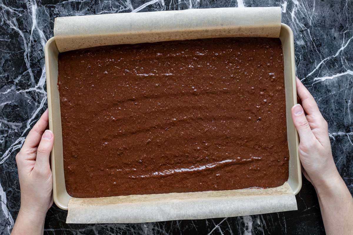 the cake batter spread out in the cake pan