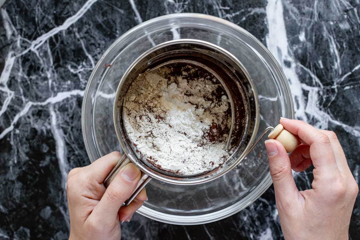 the sifter over a bowl, filled with the dry ingredients