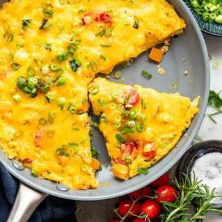 the best recipe for veggie frittata shown from overhead with a slice cut free