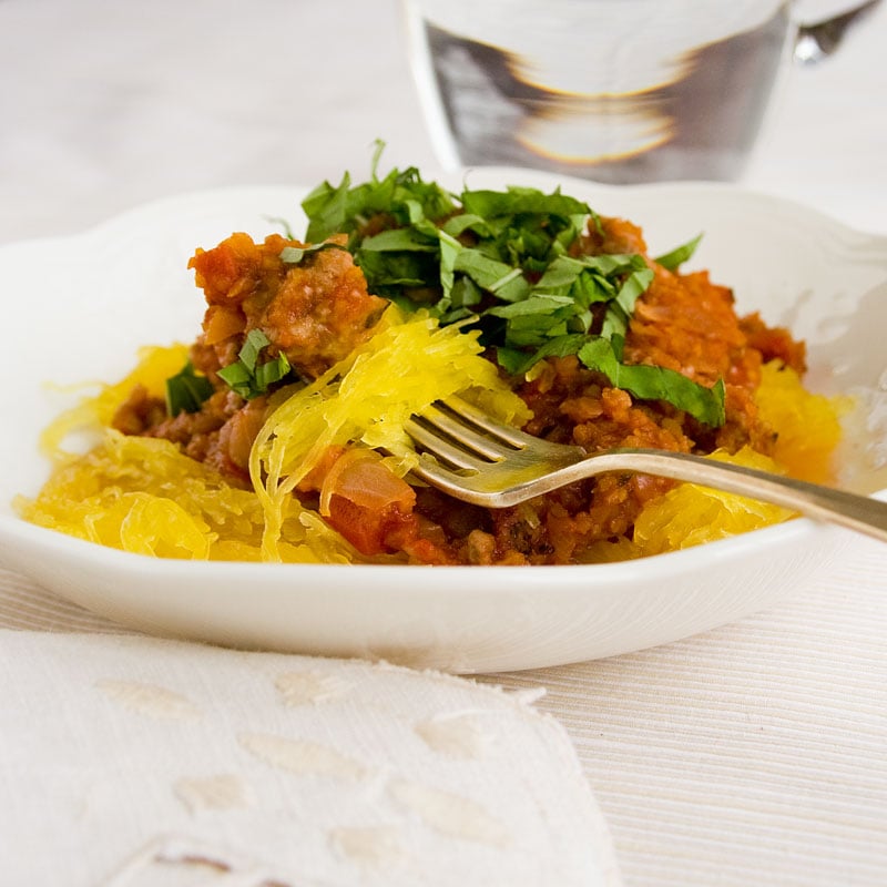 spaghetti squash with meat sauce and basil in a bowl