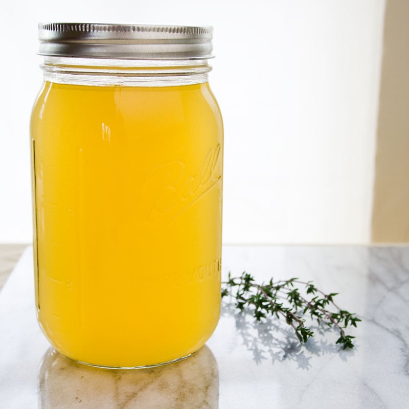 A glass jar with chicken stock