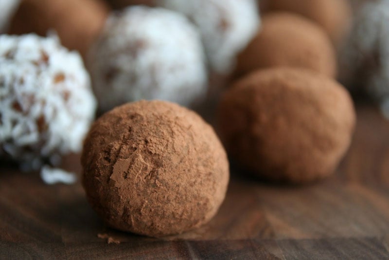 close-up of the rum balls on a wooden board
